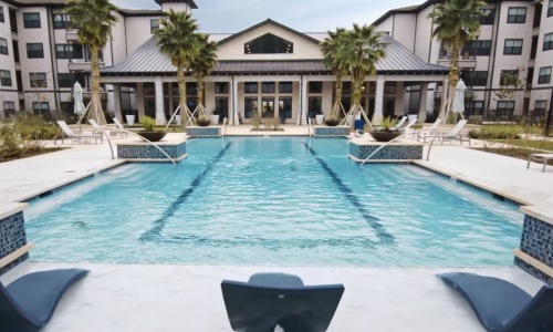 a swimming pool with lounge chairs